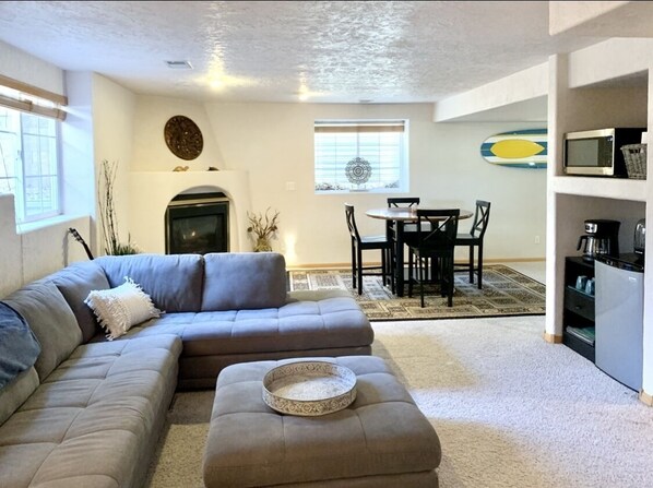 Clean and bright living room, dining area & fireplace