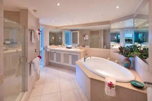 En suite master bathroom with tub, walk-in shower and double vanity