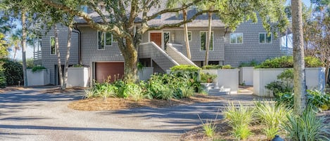 View of front of home features a beautiful live oak.