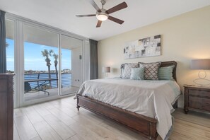 Primary Room - Wake up to stunning water views in this beautifully appointed primary bedroom. Seamlessly blending indoor and outdoor living, the expansive sliding doors open to a private balcony, creating a serene and luxurious retreat.