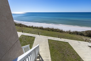 View down the balcony that lead to the boardwalk below and beach.
