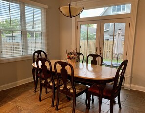 Dining area with french doors to backyard. 