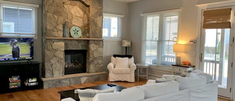 Downstairs living room with fireplace and large smart tv