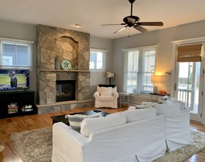 Downstairs living room with fireplace and large smart tv