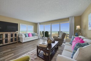 Fully furnished living room with two queen sofa sleepers