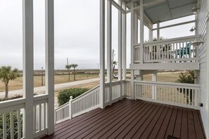 Front of home has multiple balconies looking at Galveston Bay and sunset.