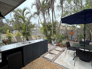 Private backyard with grill, outdoor dining and a spot to relax w a good book.