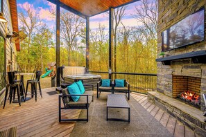 Outdoor porch area with hot tub, fireplace, TV, Giant Connect 4