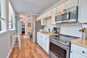 Full kitchen with oven, stove, refrigerator, and microwave