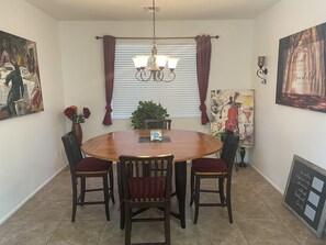Dining room table with sides pulled up to make it a large round table.