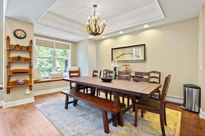 The beautiful dining area just off of the living room and kitchen features a spacious table with seating for eight and an antler chandelier.