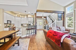 This home’s fabulous open-concept layout is evident in this photo, showing the ideal proximity of the shared spaces that allows you to be central to the fun no matter where you are.