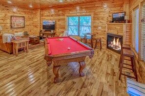 Game room with pool table, and game barrel with all the favorite classics.