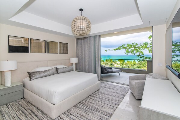 Primary bedroom with King bed and balcony overlooking sea