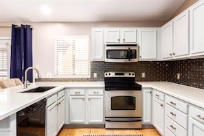 Large open kitchen w/ stainless steel appliances