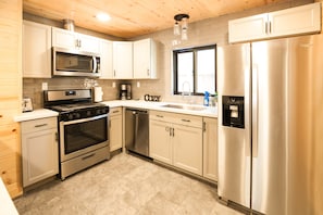 Fully stocked kitchen with a breakfast bar. 