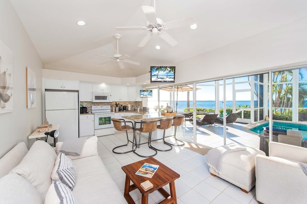 The living area opens up to the screened pool atrium.