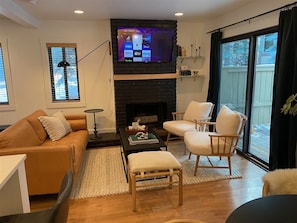 Living Room with Wood Fireplace and Large Screen TV