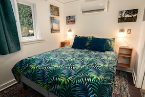 Enjoy a peaceful night's sleep in the queen size bed with memory foam mattress and organic cotton bedding.
