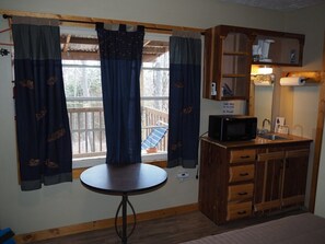 MAIN ROOM:  Includes a full-size bed, table, and small sink / kitchenette.