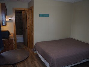 MAIN ROOM:  Includes a full-size bed, table, and small sink / kitchenette.