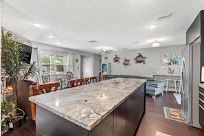 Kitchen Features a Large Island with Granite Countertop