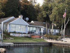 front of house looking out over dock and water.