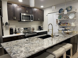 Kitchen with granite counter-tops and seating.