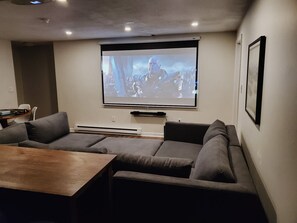 Home theatre screen with a cozy sofa pit