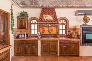 Kitchen with stove top and oven .