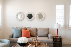 Charming sitting area with a comfy sofa and modern coastal accents — a perfect spot to unwind in Washington, Utah