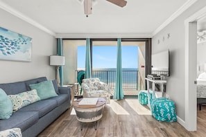 Spacious Open Living Area with Sofa and Love Seat with a Queen Size Sleeper Sofa and floor to ceiling views of the Gulf of Mexico