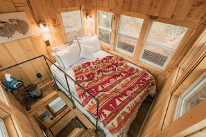 Climb up to the top of the treehouse to sleep in this comfy bed surrounded by windows! You have nearly 360 Degrees of unobstructed views of Bluebird Farm!