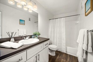 Bathroom w/ toiletries  & bathtub