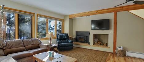 Living room with flat screen TV and wood burning fireplace
