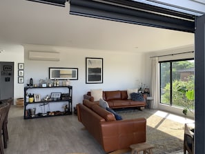 Living space upstairs, with smart TV and views over sand dunes and ocean