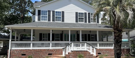 Huge home with rocking chair front porch.  