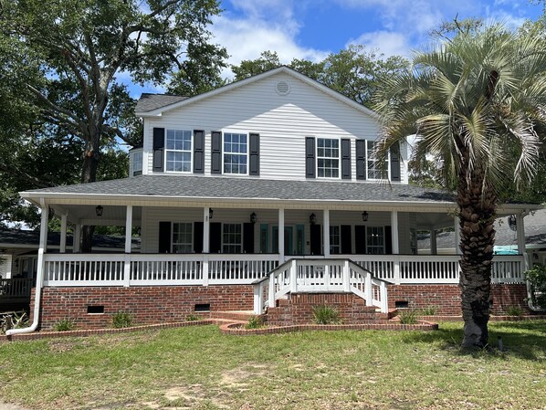 Huge home with rocking chair front porch.  