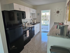 Galley Kitchen with brand new cabinets, granite & appliances