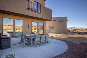 Back Patio - The Back Patio includes an outdoor dining table, BBQ grill, and sliding glass door that leads into the living room.