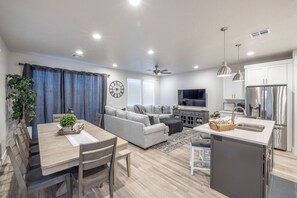 Living Area View - The living room is conveniently adjacent to the kitchen. There is also access to the back patio which has a BBQ grille suitable for all your favorite BBQ dishes.