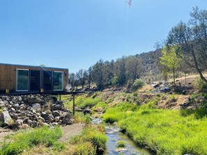 house suspended over creek 