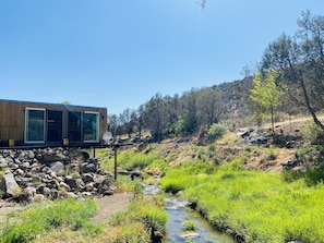 house suspended over creek 