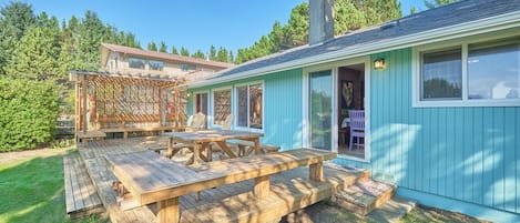 The large cedar deck with comfy Adirondack chairs and a picnic table offers a tranquil outdoor setting for this delightful retreat.