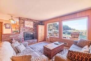 The airy, open living room is outfitted with cable TV/VCR/DVD, CD/Tape Player/Radio, extra movies, books, games, and toys.