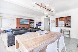 View from the dining area to the living area and kitchen.
                