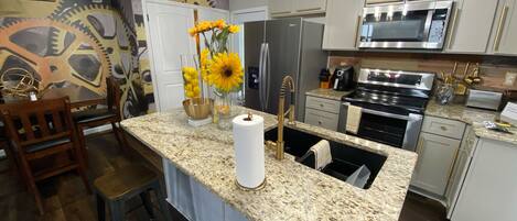 Beautiful kitchen with bar and eat in dining