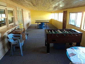 Game room with ping pong, foosball, board games, and yard games.