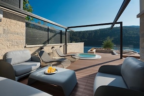 Cozy sunbeds and hot tub by the sea in Labin Luxury family Villa Palace for vaaction and rent.