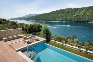Sunbathing area near private pool with deck chairs of Labin seafront Luxury Villa for vacation and rent.